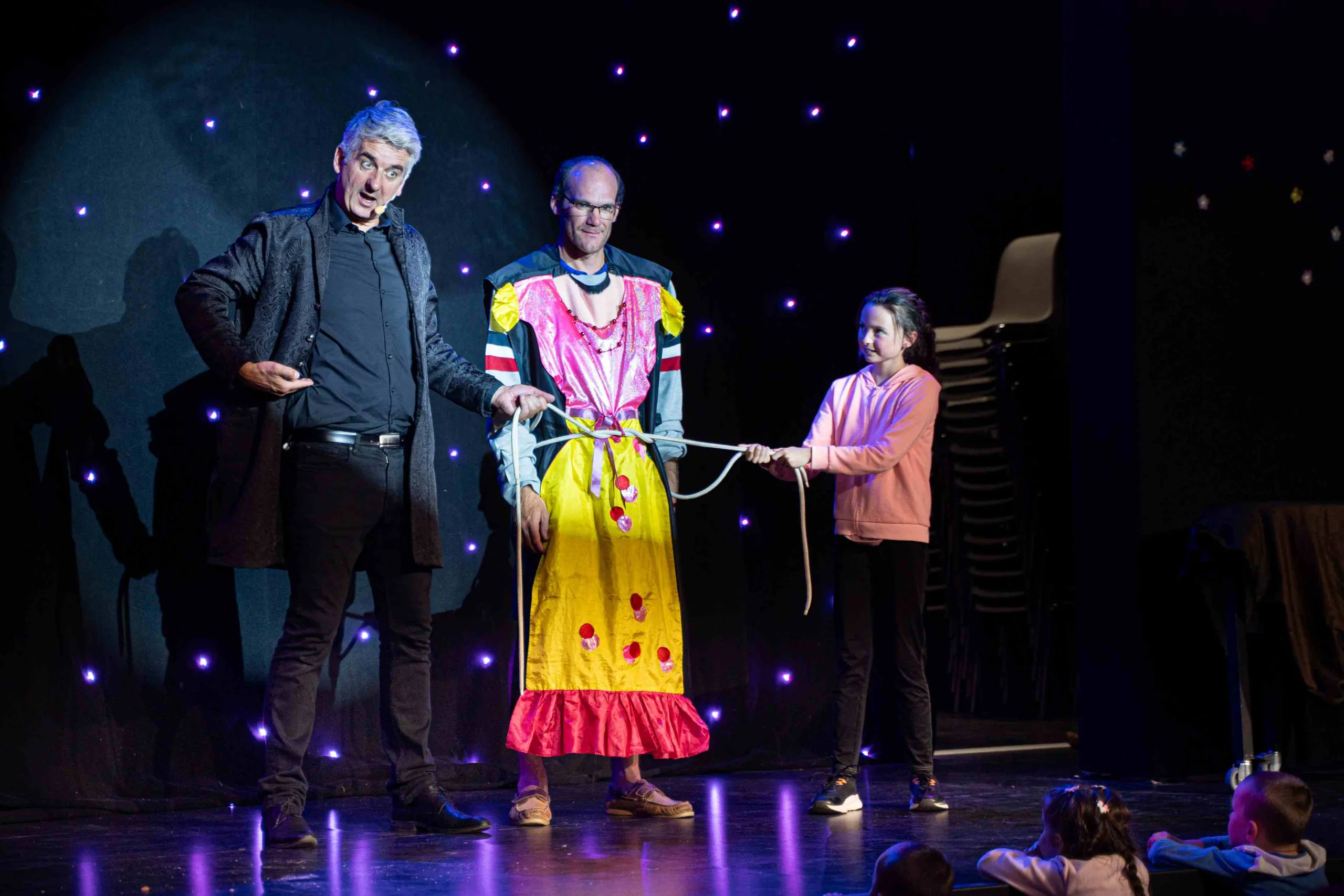 Spectacle de magie avec robe colorée sur scène.